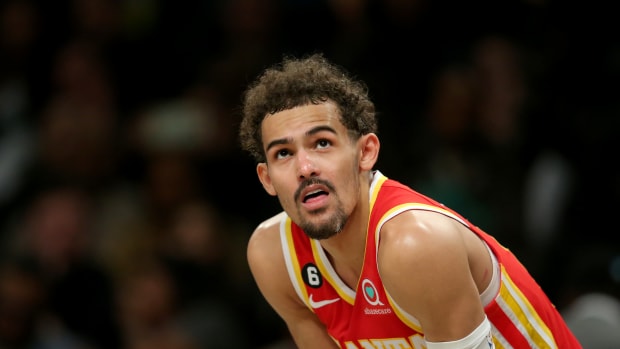 Trae Young looks at the scoreboard during a game.